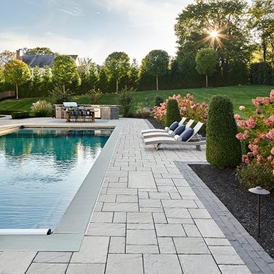 Evening outdoor living space with lighting by Bollman Landscape